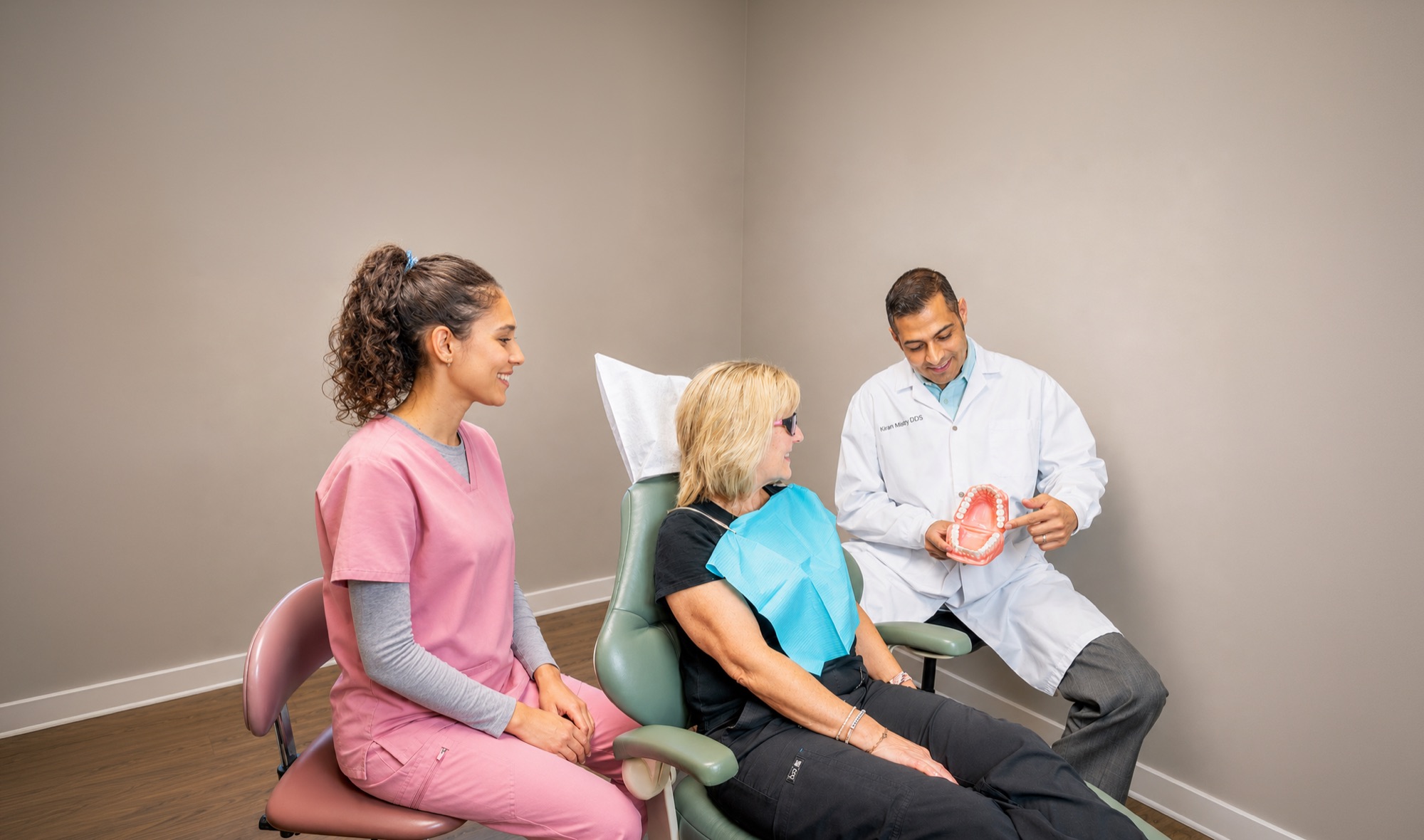 Dr. Kiran Mistry and his hygienist with a patient